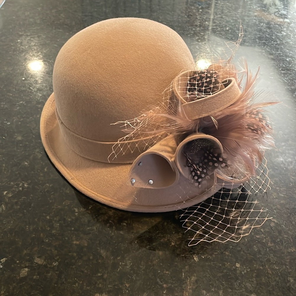 This adorable bowler/cloche hat is from JJs House, and 100% wool.